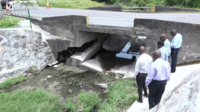 A team of officials from the Nevis Island Administration checking damage to the Bath Bridge on May 15, 2017, following recent heavy rains